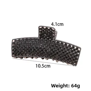 Macro view of large dark grey rhinestone shark hair claw clip with size dimensions