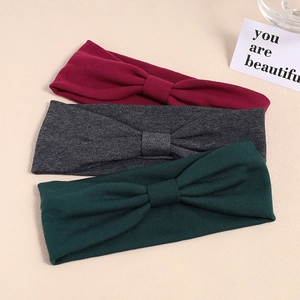 Three-pack elastic knotted headbands in burgundy, dark gray, and green knit fabric