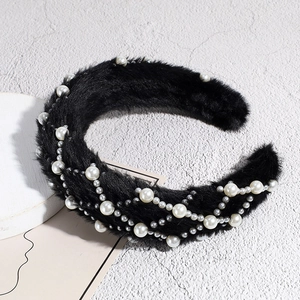 Detailed view of plush black headband featuring elegant faux pearls and silver beads