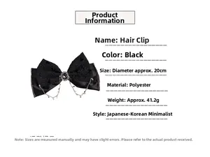 Detail of a large black bow hair clip with rhinestone tassels and star charms