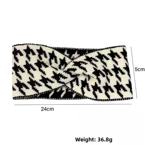 Detail view of houndstooth knit headband showing 24cm length and twisted design