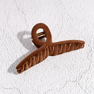Macro shot of large brown flocked square hair claw clip with twisted ring design