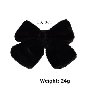 Detailed view of plush black bow hair clip measuring 15.5cm wide and weighing 24g