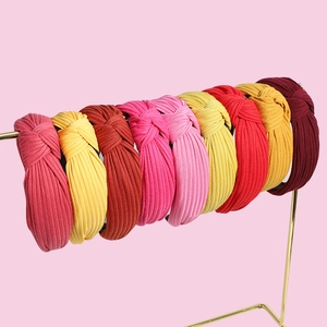 Set of eight stylish knotted wide headbands in various vibrant colors and ribbed fabric