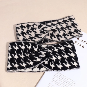 Detail of knit houndstooth headbands with twisted cross design in black and white