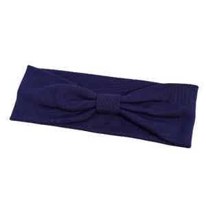Elastic navy blue yoga headband with a decorative central knot on a clean white background