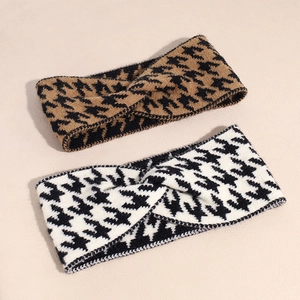 Detail of knitted houndstooth headbands showing thick yarn texture and cross knot design