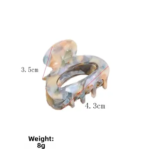 Detailed view of acetic acid hair claw with marble texture and dimensions 4.3cm by 3.5cm