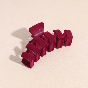 Detailed view of the dark red velvet flocking texture on a large square hair claw clip