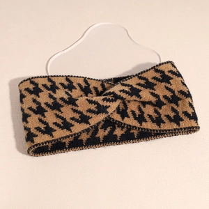 Detail of black and brown houndstooth knitted headband with vintage twist knot texture