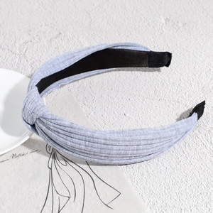 Detailed view of knots on light blue ribbed knitted headband with non-slip lining