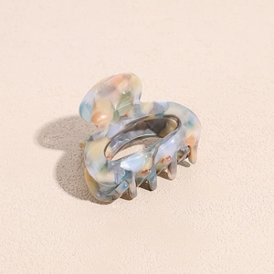 Close-up of mixed marble texture acetate hair claw clip with colorful pattern finish