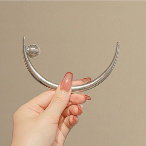 Elegant silver crescent moon hair pin with a white pearl accent for bun hairstyles