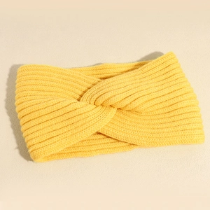 Elastic mustard yellow knit headband with a stylish crossover twist for autumn warmth