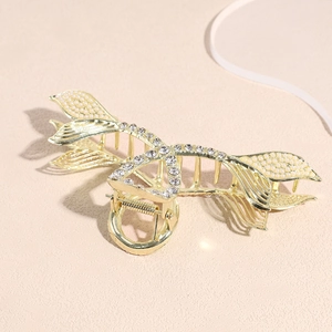 Elegant gold fishtail hair claw with sparkling rhinestones and white faux pearls