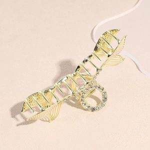 Elegant gold metal fishbone hair claw clip with rhinestones and pearl accents