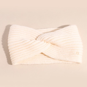Detailed close-up of cream knit twist knot headband with clear vertical ribbed texture