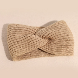 Detailed macro view of khaki knitted twist headband featuring classic ribbed wool texture