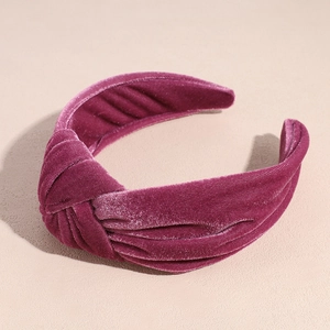 Detail of the twisted knot design on this deep purple velvet headband with plush texture