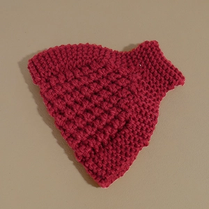 Detailed macro shot of red knitted headband showing thick textured crochet wool pattern