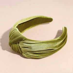 Detailed close-up of olive green velvet knotted headband with soft plush texture