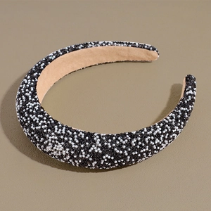 Close-up of pearl beaded baroque headband with black and white contrast embellishments