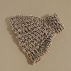 Macro detail of the thick brown wave knit texture on a warm winter headband