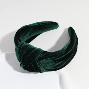 Detail of the emerald green velvet knotted headband texture and twisted fabric design
