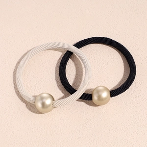 Set of two elastic pearl hair ties in black and beige with matte gold bead accents