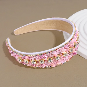 Detailed macro view of pink turquoise beads and square rhinestones on a baroque headband