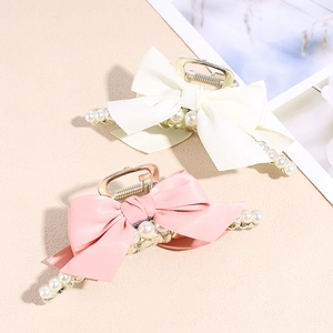 Elegant bow hair claw clip with pearls in creamy white and light pink silk finish