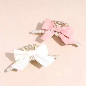 Elegant bow hair claw clip with pearls in pink and white satin for stylish women