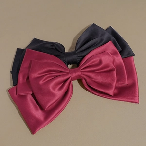 Set of large satin bow hair clips in wine red and black for an elegant women hairstyle