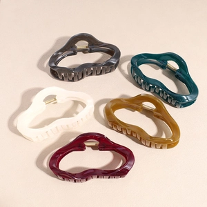 Five assorted colors of large vintage wavy acetate hair claws with gold metal springs