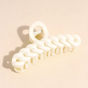 Macro shot of milk tea cream large hair claw clip with matte chain link design