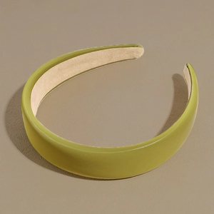 Detail view of avocado green PU leather headband with non-slip velvet inner lining