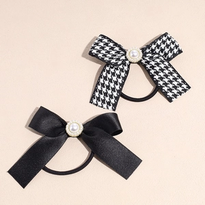 French style bow hair scrunchies with pearls and houndstooth pattern on beige surface
