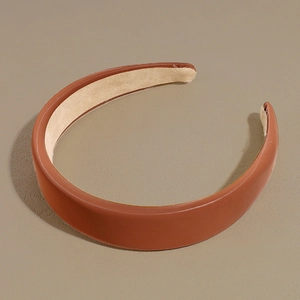Detail showing high-quality brown PU leather texture and smooth stitching on wide headband