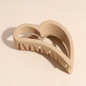 Macro detail of almond heart hair claw clip with matte resin finish and firm grip teeth