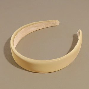 Close-up of matte PU leather headband in cream yellow with non-slip lining