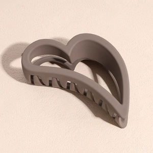 Close-up of matte mocha brown hollow heart hair claw clip with smooth frosted texture