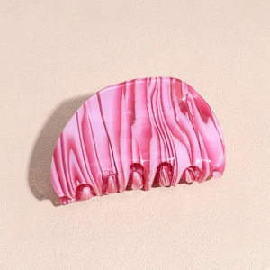 Detail of pink and white marble texture on a crescent acetate hair claw clip