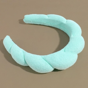 Detailed close-up of mint green padded headband featuring twisted sponge fabric texture