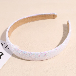 Detailed view of white sequins headband with soft beige velvet lining and shimmering texture