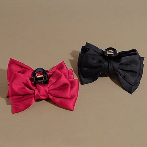 Set of large satin bow shark hair clips in magenta and black with elegant layered ribbons