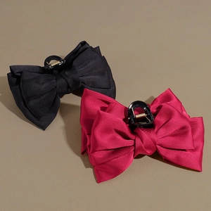 Elegant large satin bow hair claws in black and rose red for voluminous hairstyles