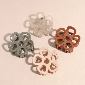 Set of four matte flower hair claws in muted tones including green and brown