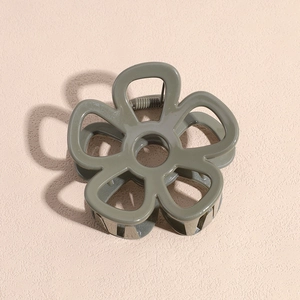 Close-up of olive green flower hair claw clip with a hollow five-petal resin design