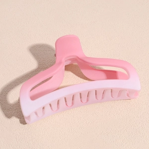 Detailed macro view of large matte pink gradient hair claw clip with sturdy comb teeth