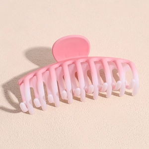 Detail shot of the matte gradient pink acrylic hair claw clip with multi-tooth grip